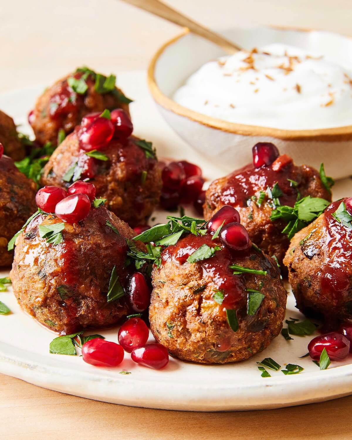 vegetarian meatballs with red sauce and pomegranates