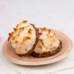 coconut macaroons dipped in chocolate on pink plate