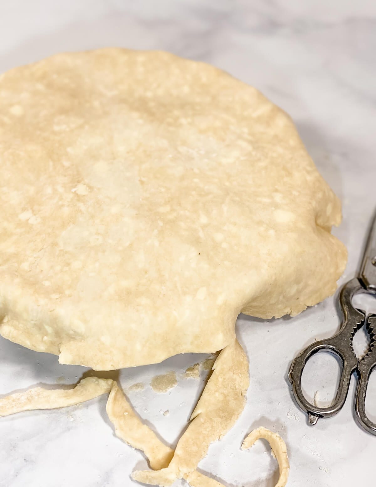 trimming pastry crust with kitchen shears