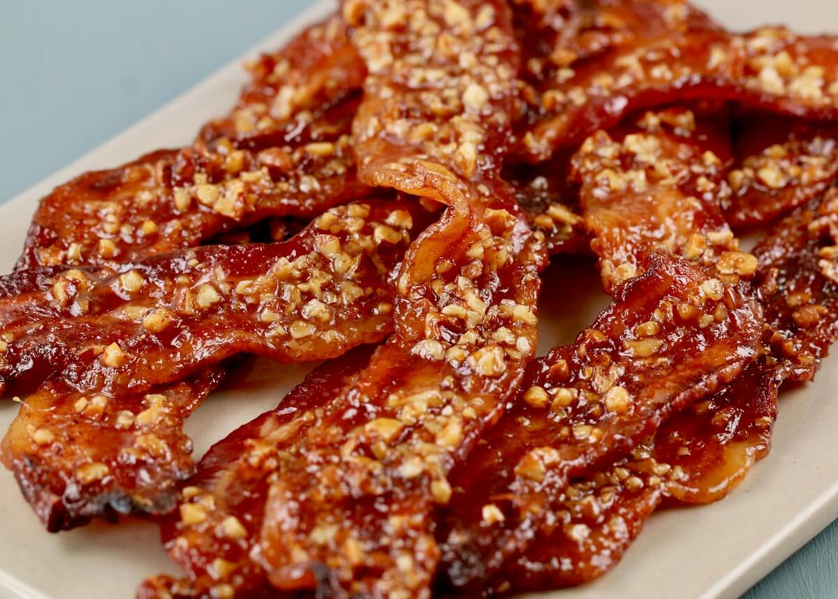 close up of maple bacon on a white platter 