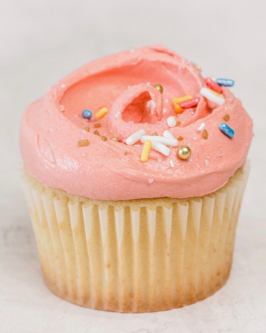 close up of pink colored birthday cupcake