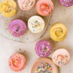 pastel colored frosted cupcakes with sprinkles