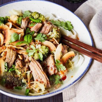pork curry with broccoli and coconut in bowl
