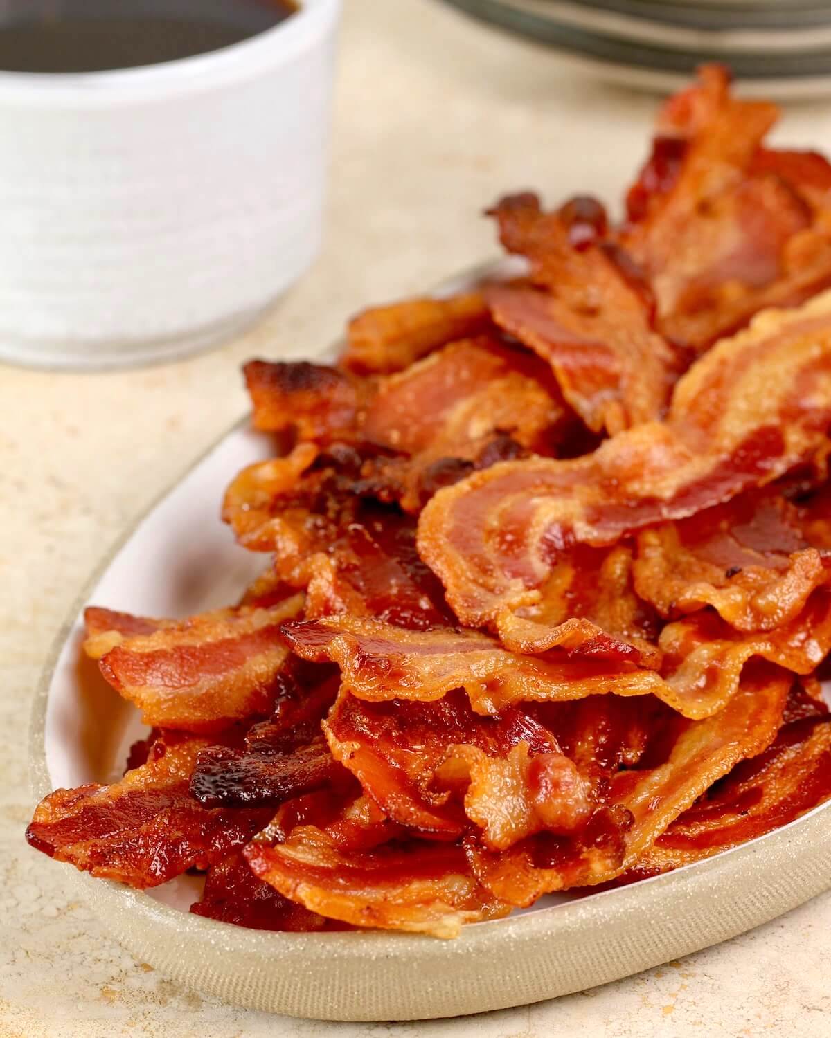 vertical image of bacon with coffee