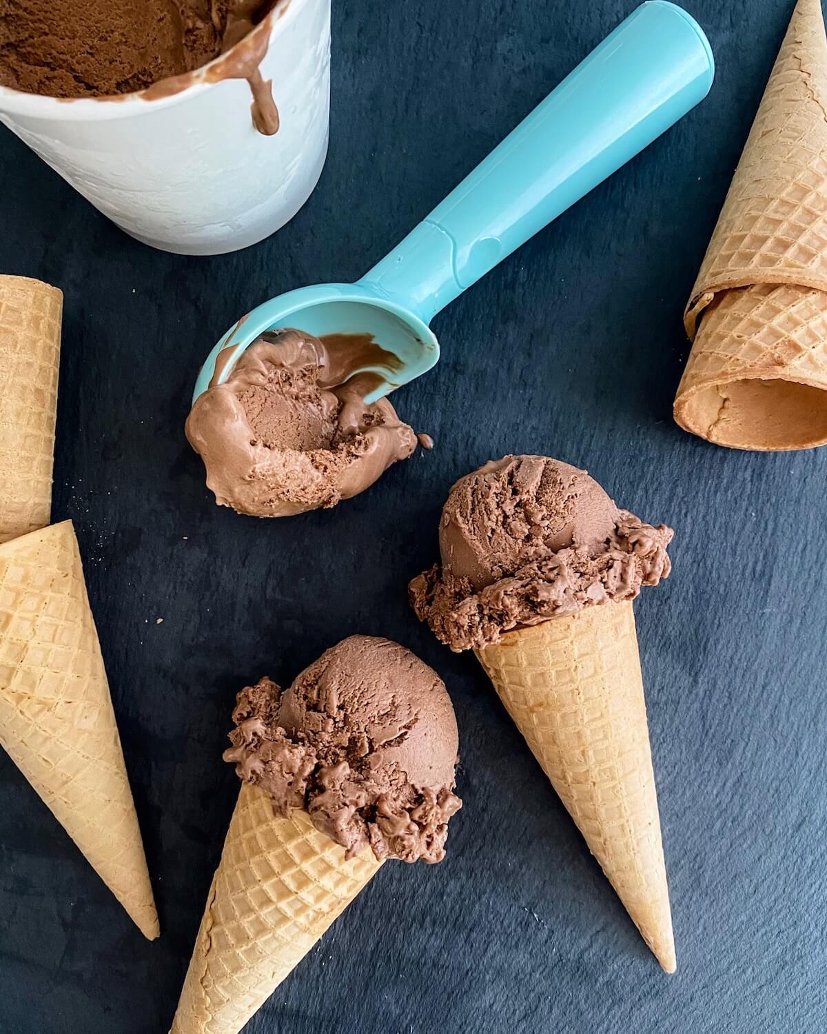 chocolate ice cream cones and blue scooper