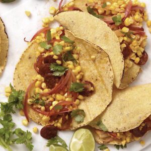 close up of chorizo and corn taco with onions