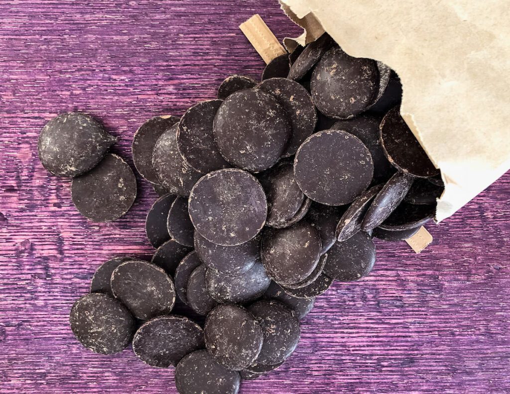 dark chocolate disks in paper bag