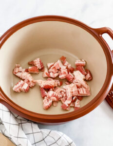 bacon cut into half inch pieces in a pot