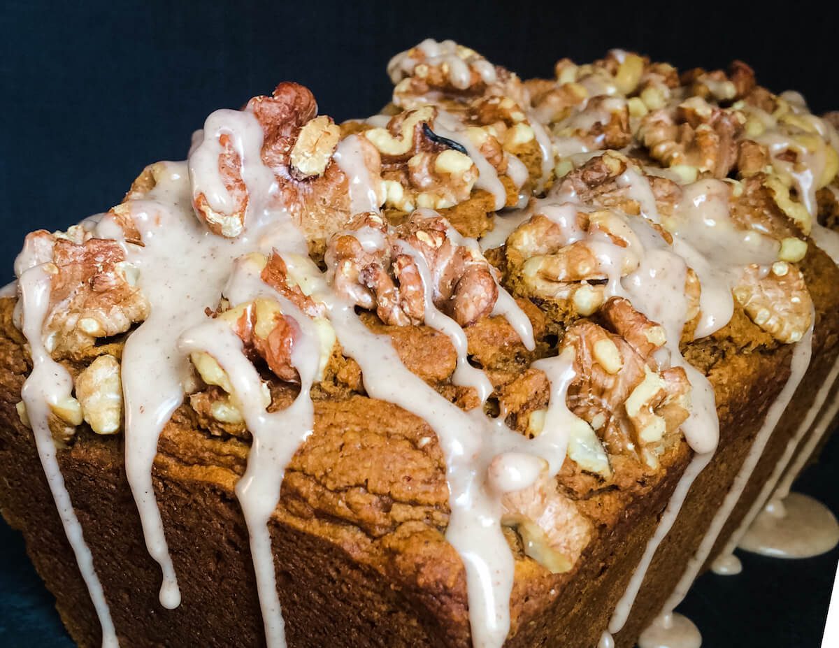 close up on icing and walnuts on pumpkin bread