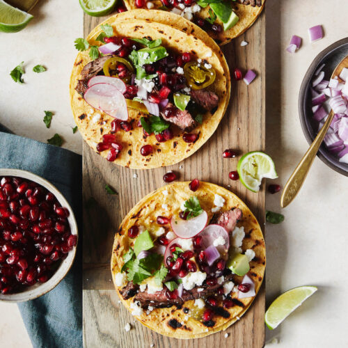 steak tacos with pomegranates radish and red onions
