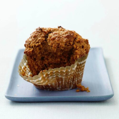 bran muffin being opened on blue plate