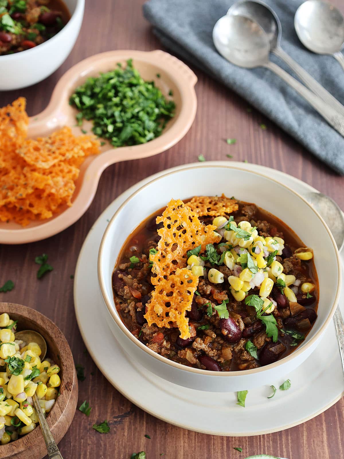 A bowl of chili with toppers. 