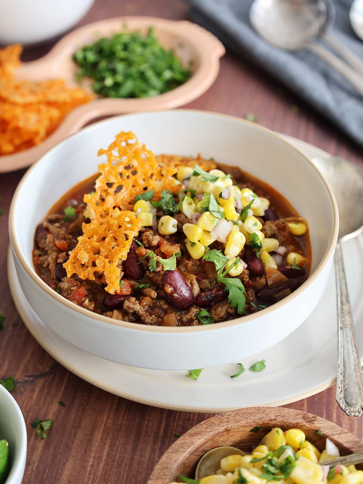 A bowl of chili with toppers. 