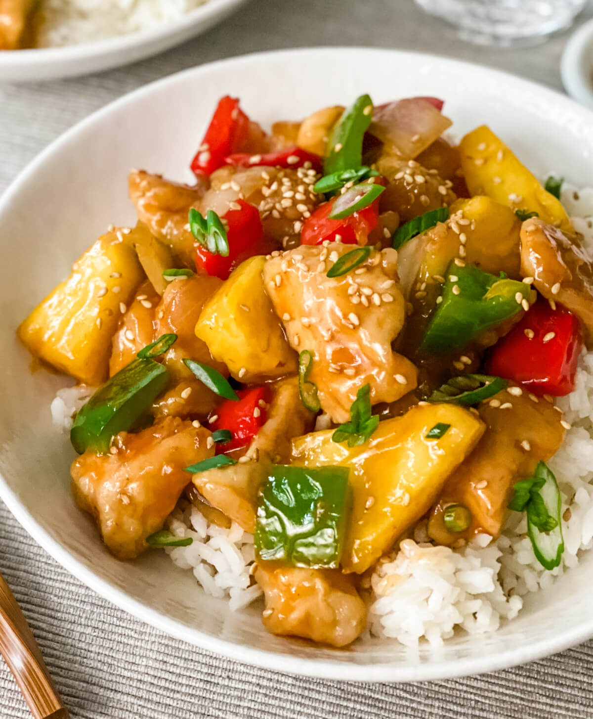 close up of sweet and sour chicken on rice