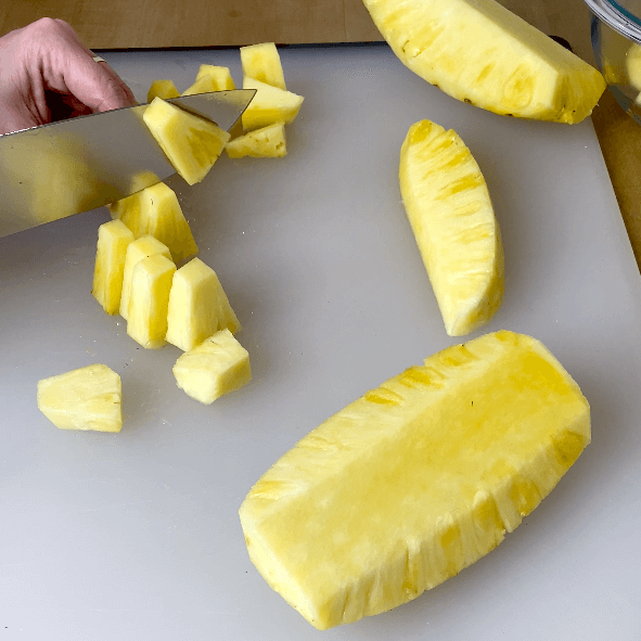 cutting pineapple into chunks