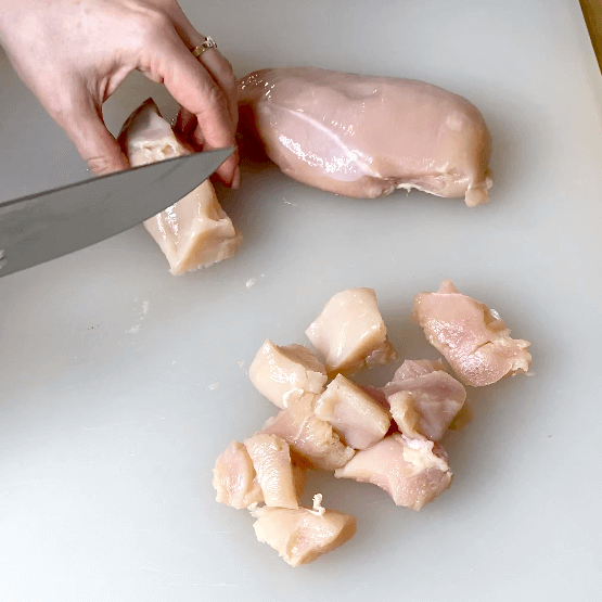 cutting chicken breasts into cubes