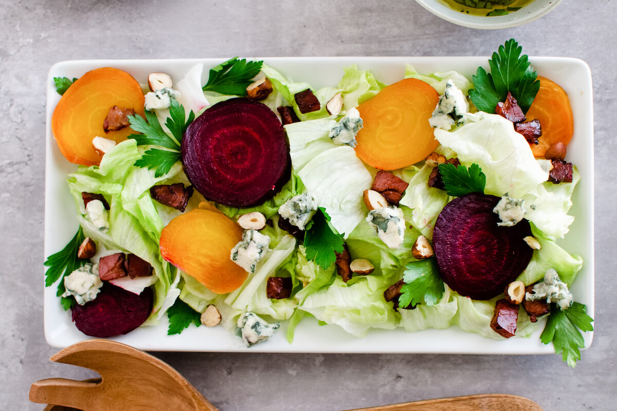 platter of lettuce wedge salad with beets and bacon