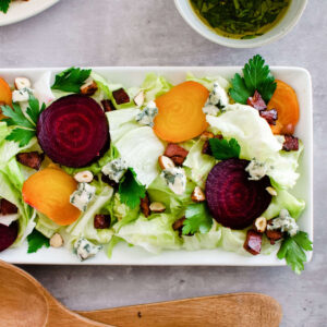 new lettuce wedge salad with beets and bacon on platter