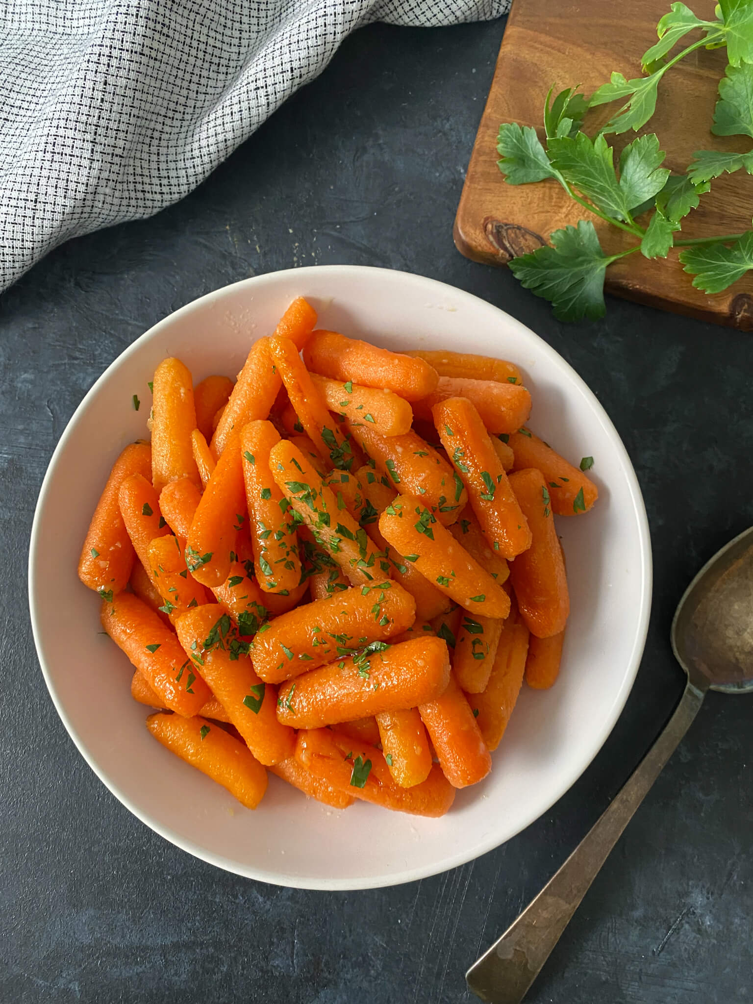 baby carrots glazed with honey in white bowl
