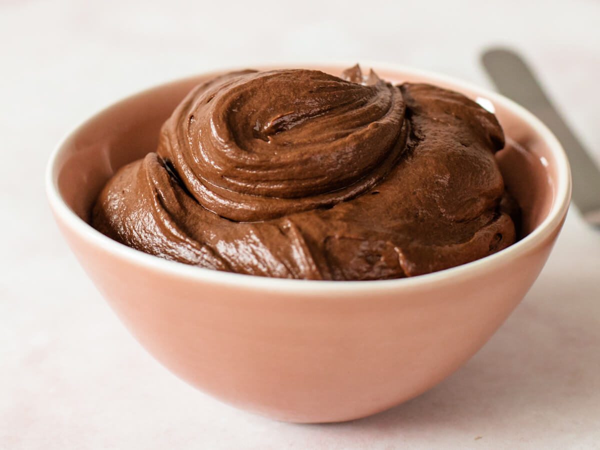 close up of ganache frosting in bowl