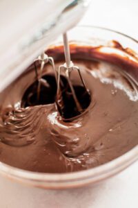 chocolate ganache getting whipped into a frosting