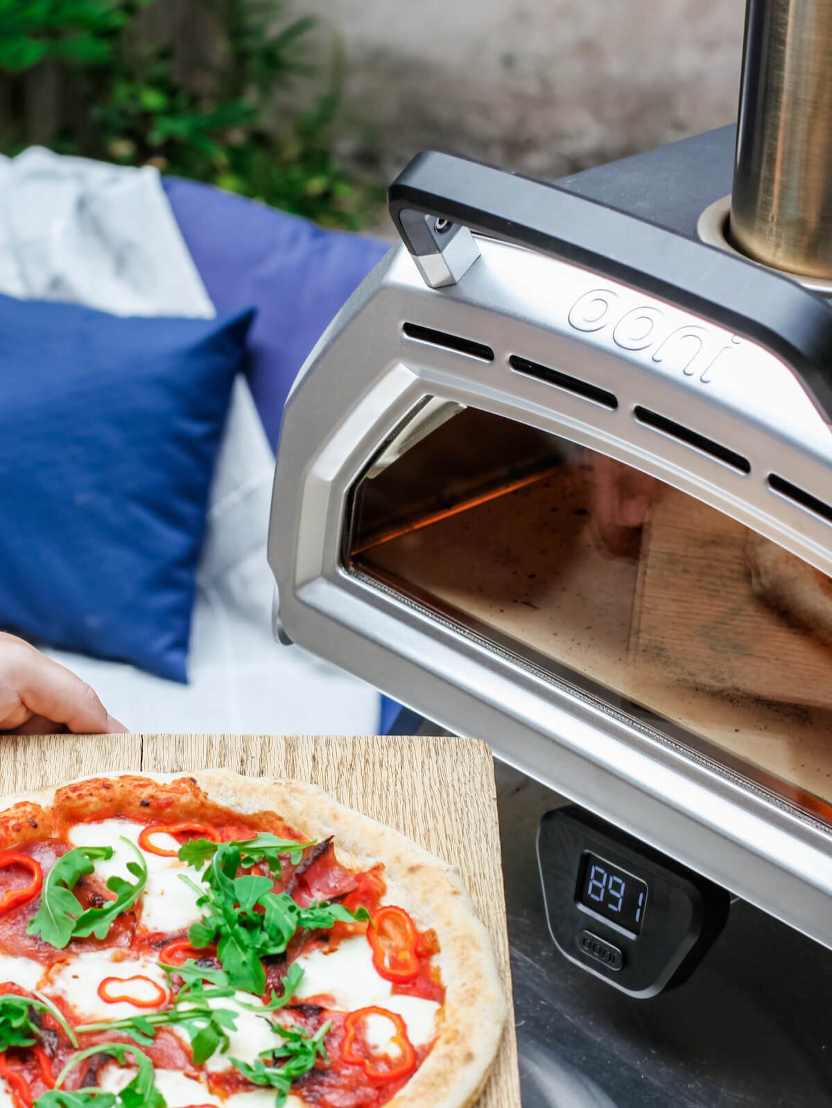 Ooni brand pizza oven in backyard