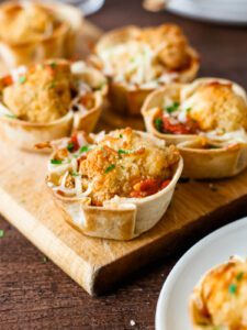 chicken parm cups on a cutting board for serving