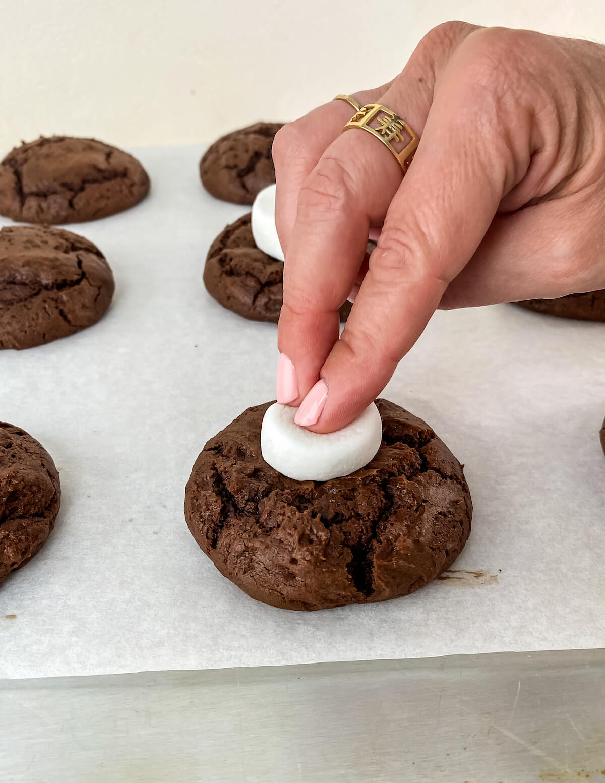 adding marshmallow to chocolate surprise valentines cookies