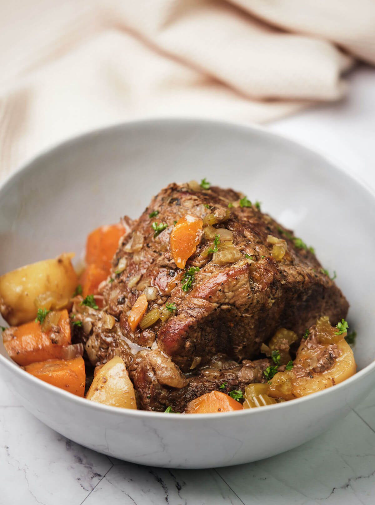 classic pot roast with potatoes and carrots ready to serve in a bowl