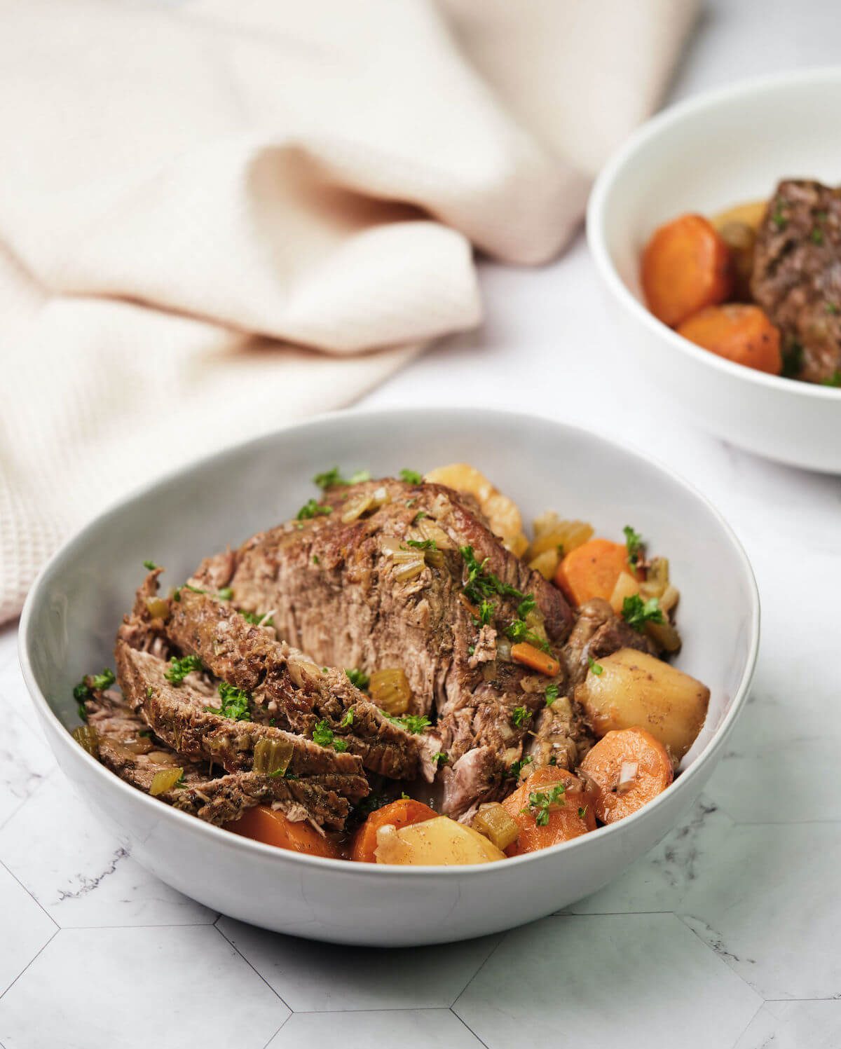 sliced classic pot roast with carrots and potatoes