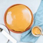 A cake topped with creamy caramel icing.