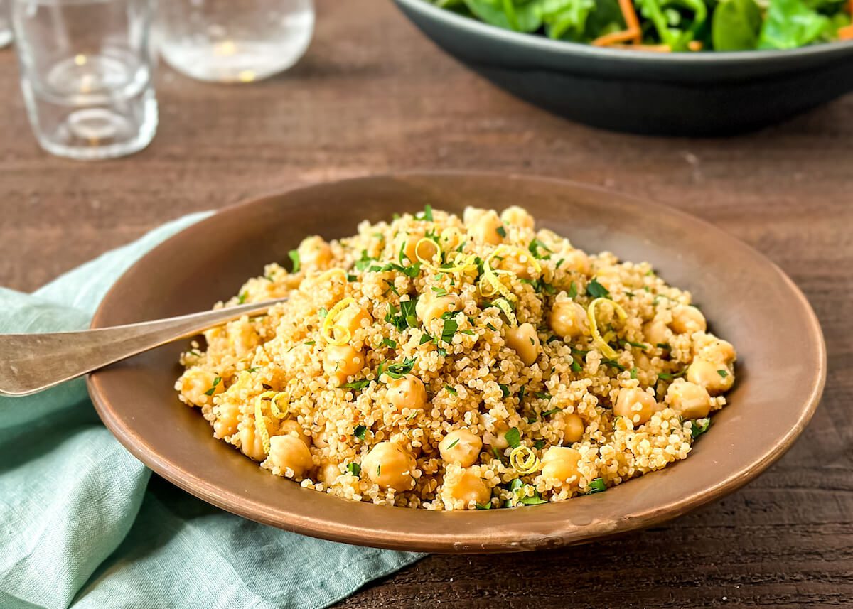 Lemon chickpeas and quinoa with zest and parsley on table