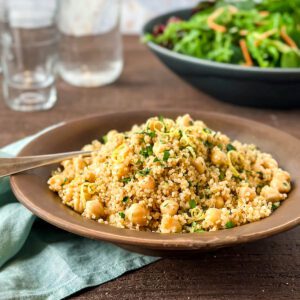 Chickpea Quinoa Salad with lemon zest and parsley in brown bowl