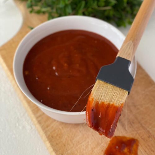 Better BBQ Sauce in a bowl with a dripping brush