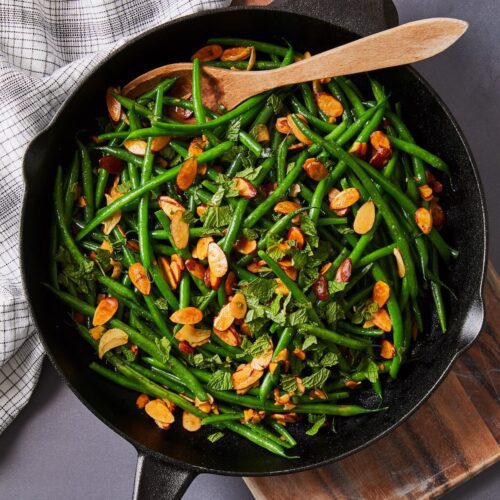Browned butter green beans with almonds in a cast iron skillet