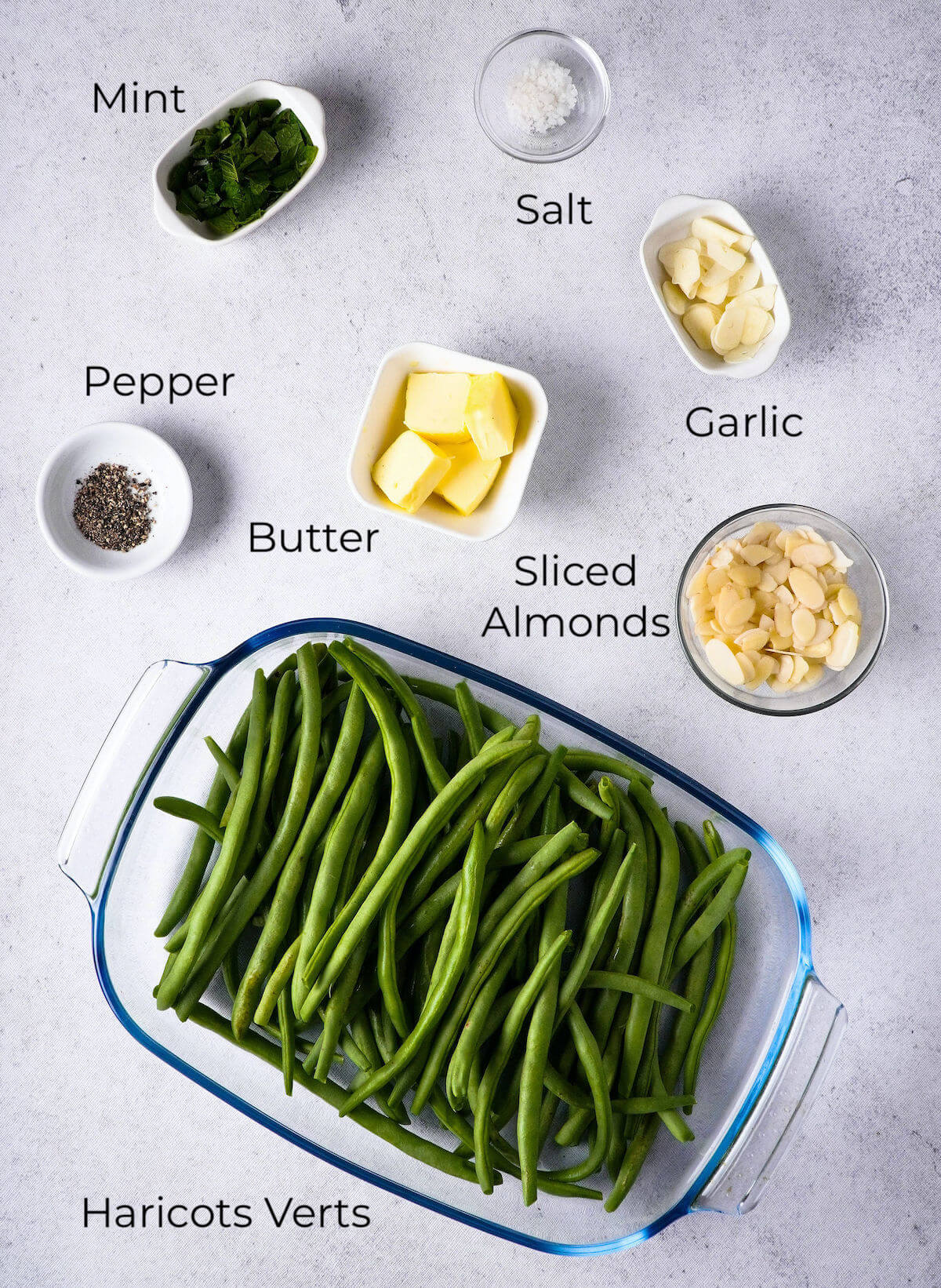 ingredients for green beans and sliced almonds in dishes