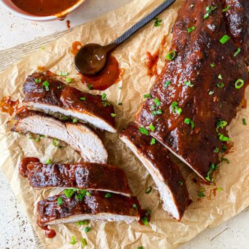 oven baked bbq ribs cut on brown parchment paper