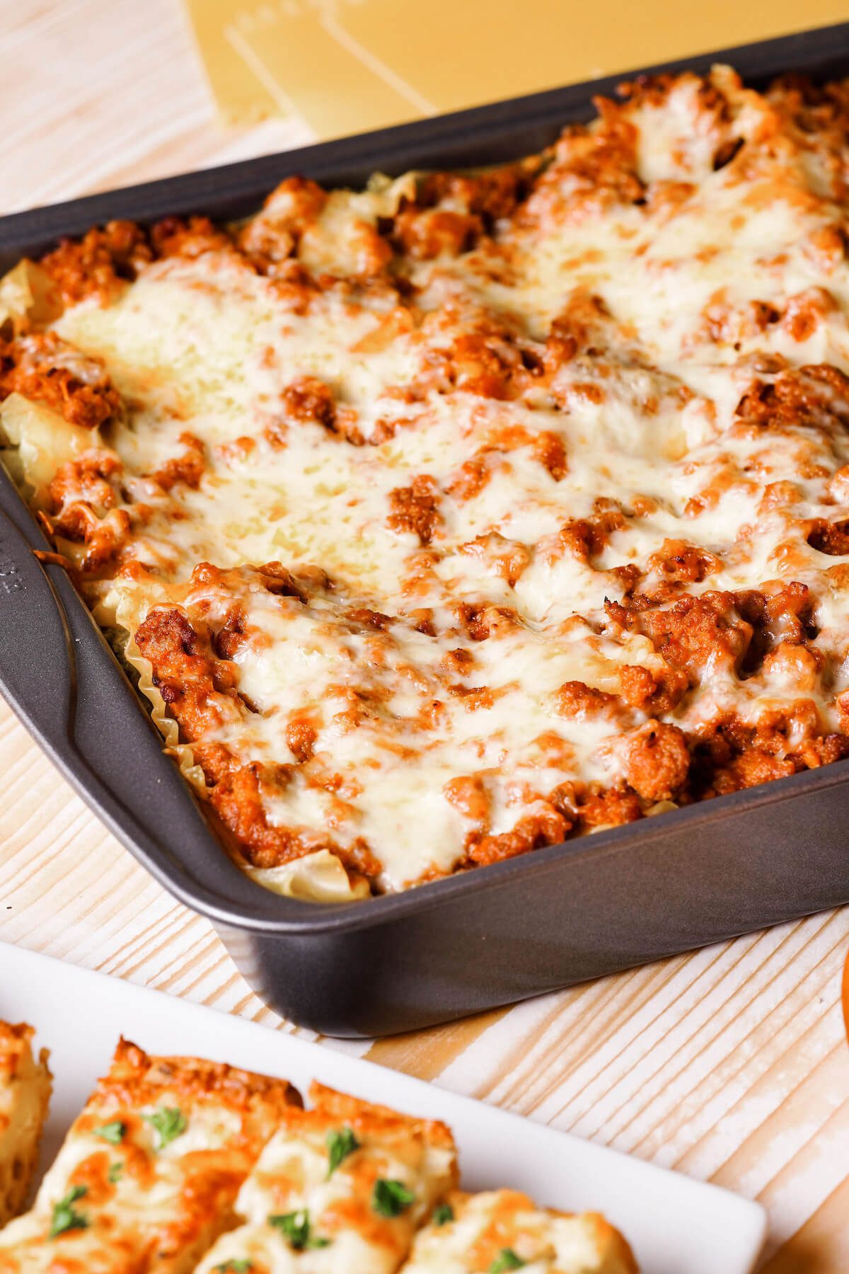 baked lasagna with cheese on top in pan