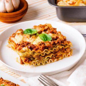 close up of cooked pesto lasagna on plate