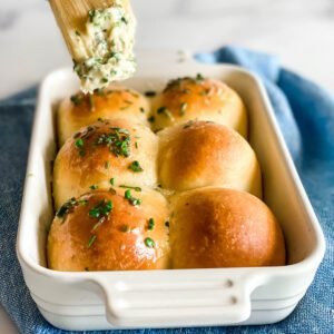 close up of dinner rolls with herb butter