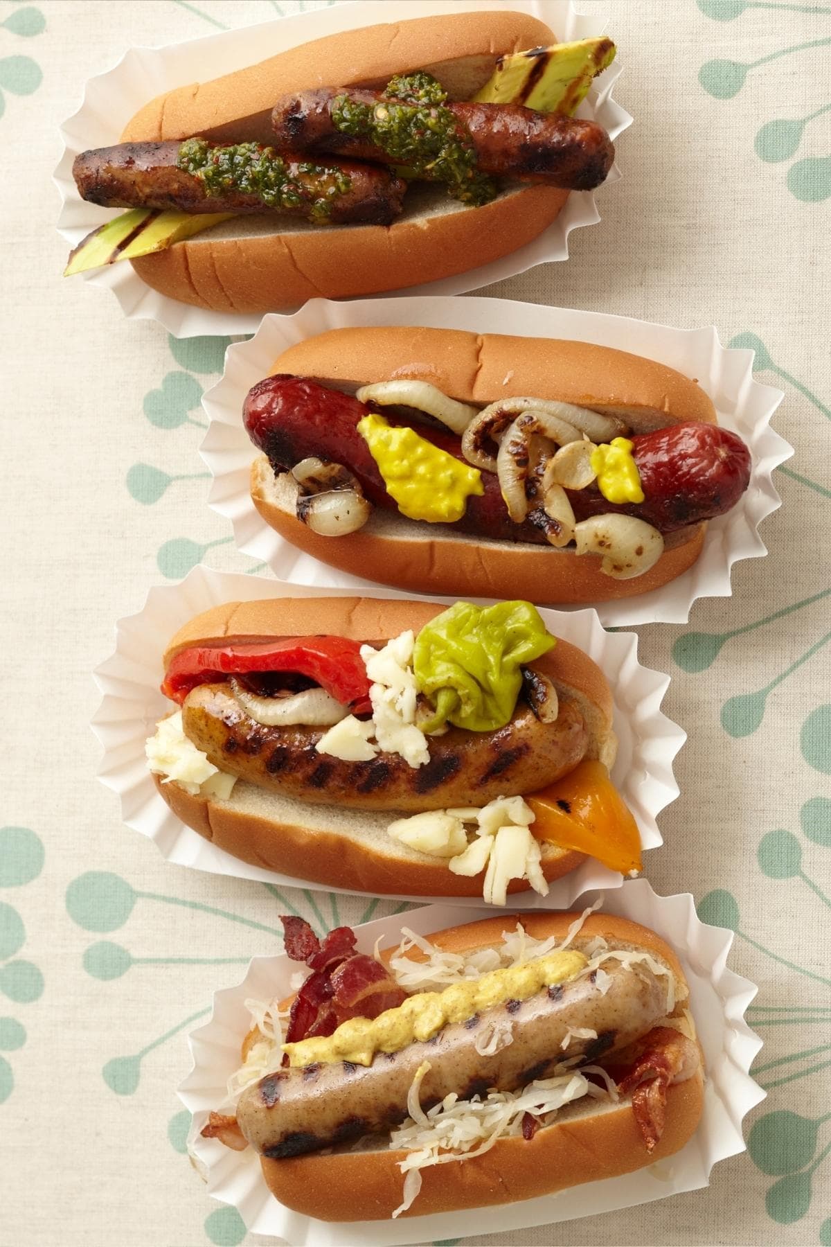 Four gourmet hot dogs in a row.