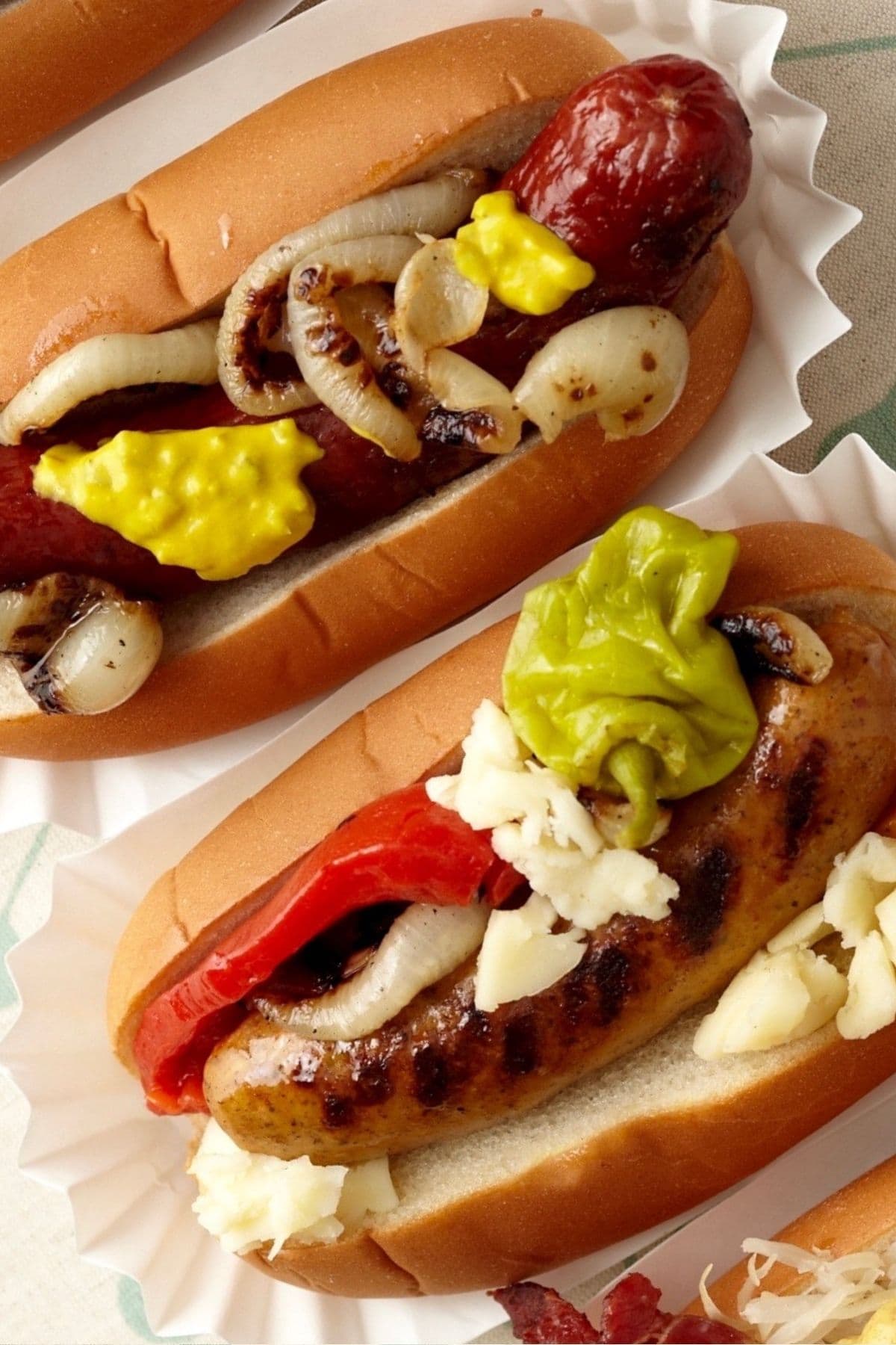 Close up of two gourmet hot dogs.