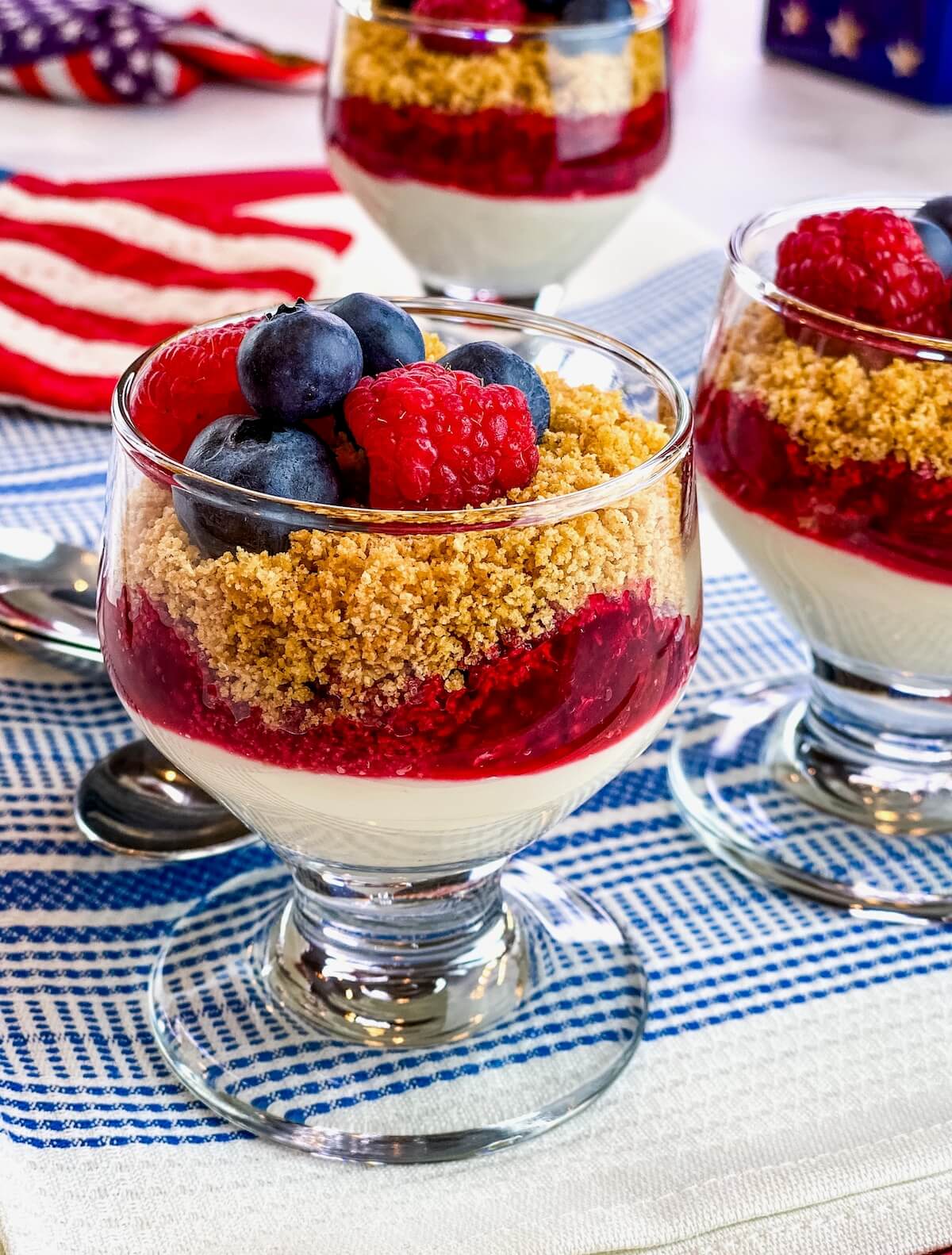 No bake cheesecake in a jar layered with fresh berries and graham cracker crumbs