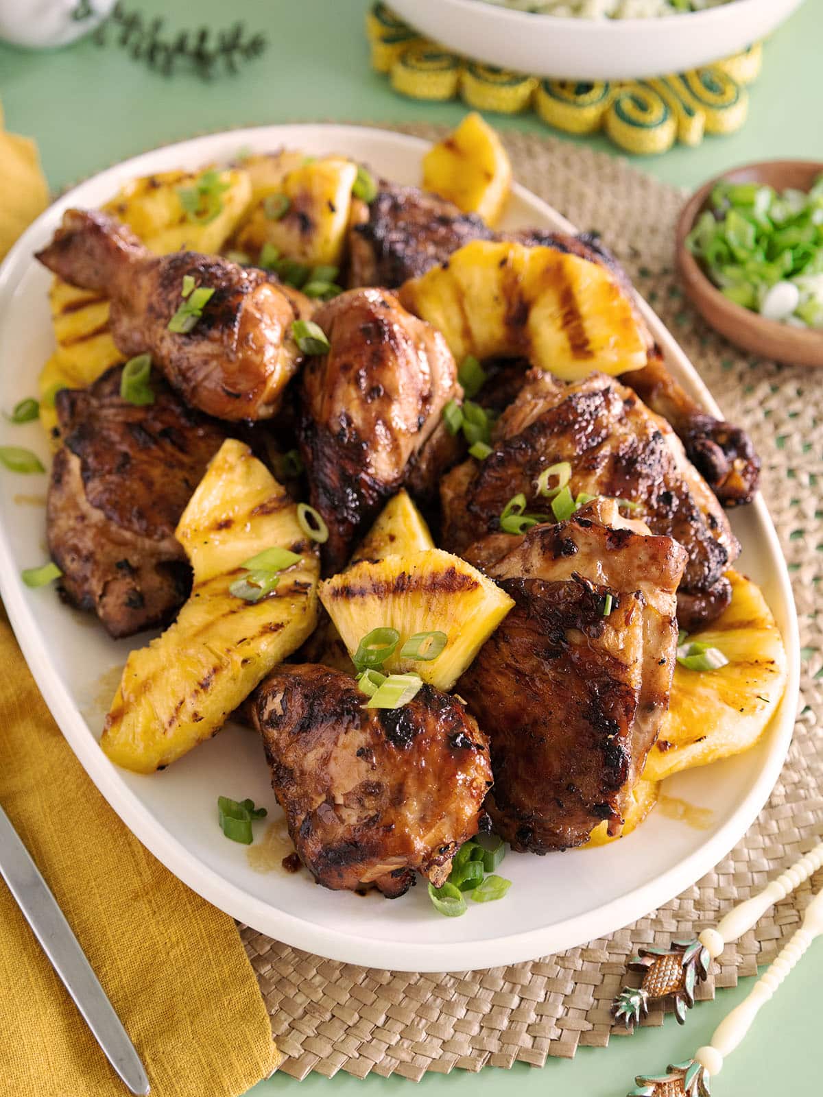 A platter of grilled chicken and grilled pineapple. 