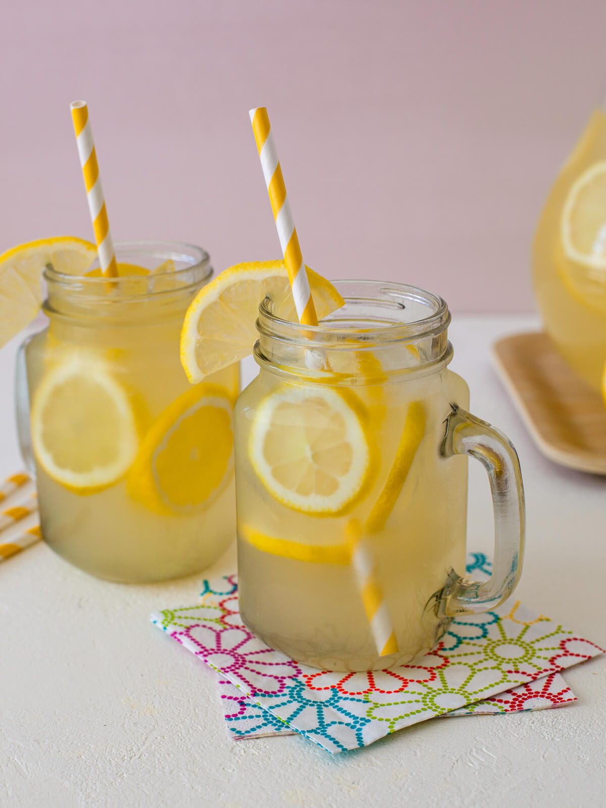 mason jar mugs of lemonade with straws