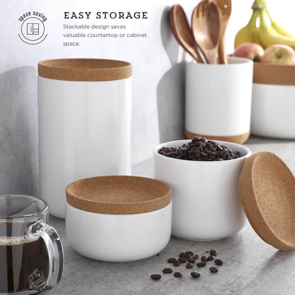 A ½ quart, 1 quart and 2 quart Kamenstein Ceramic and Cork Stackable Canister in white, set in a kitchen filled with coffee ingredients.