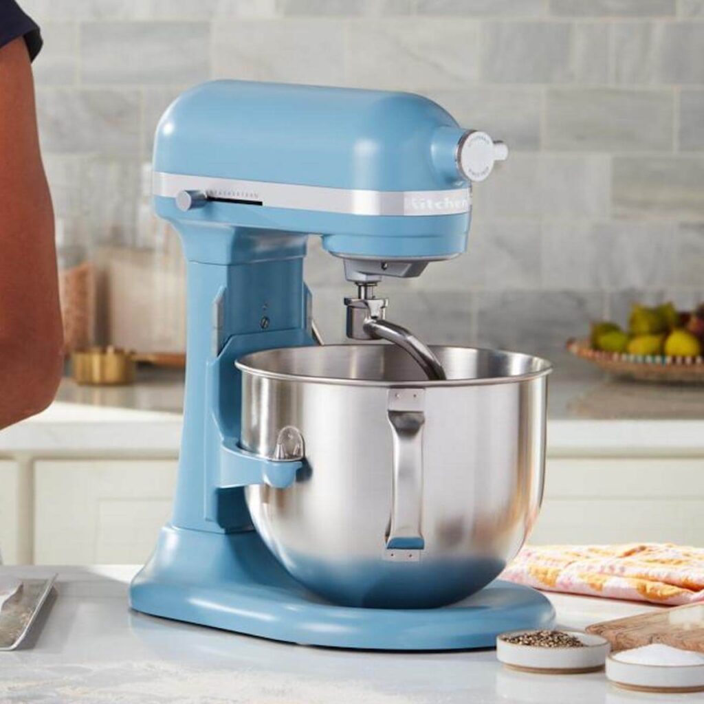 7-Quart, Blue Kitchen Aid Stand Mixer in a kitchen with a marble countertop.