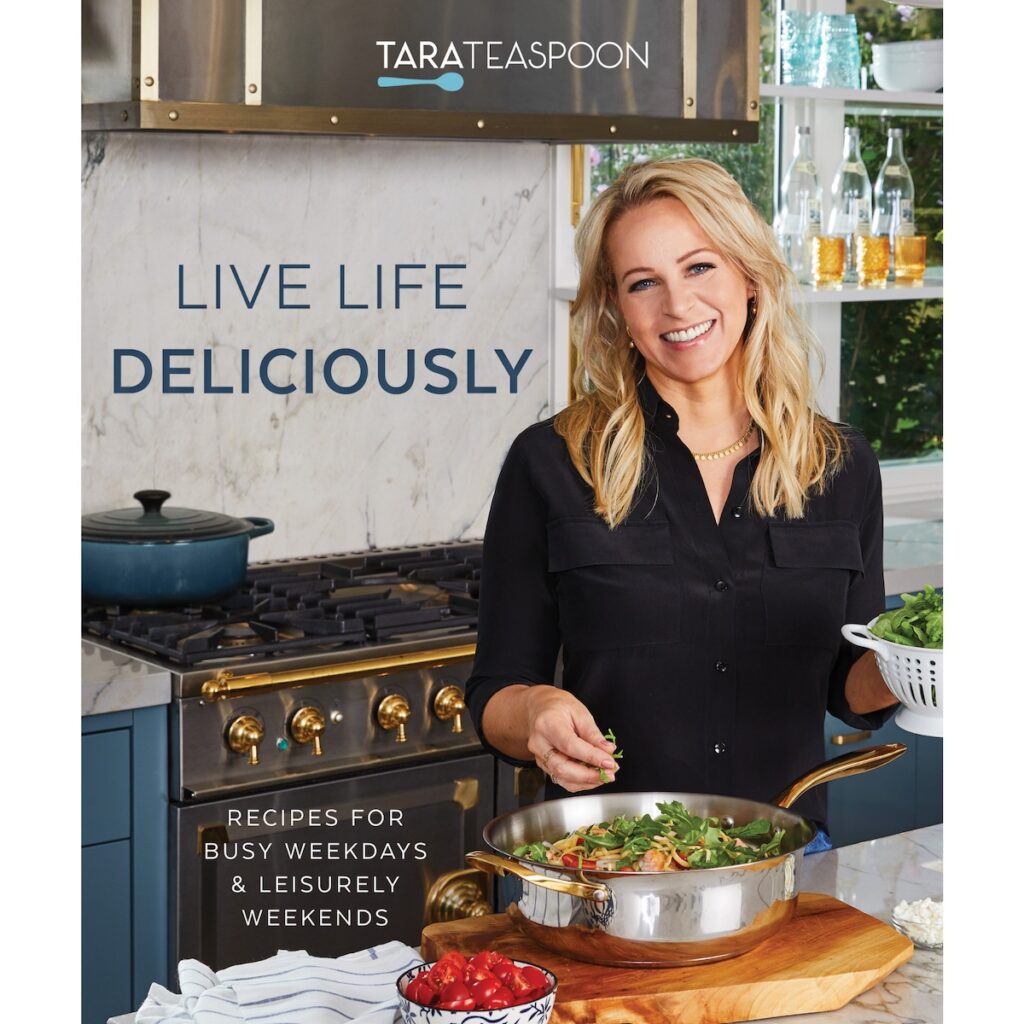 Live Life Delicious Cookbook cover featuring Tara Bench cooking in her kitchen.