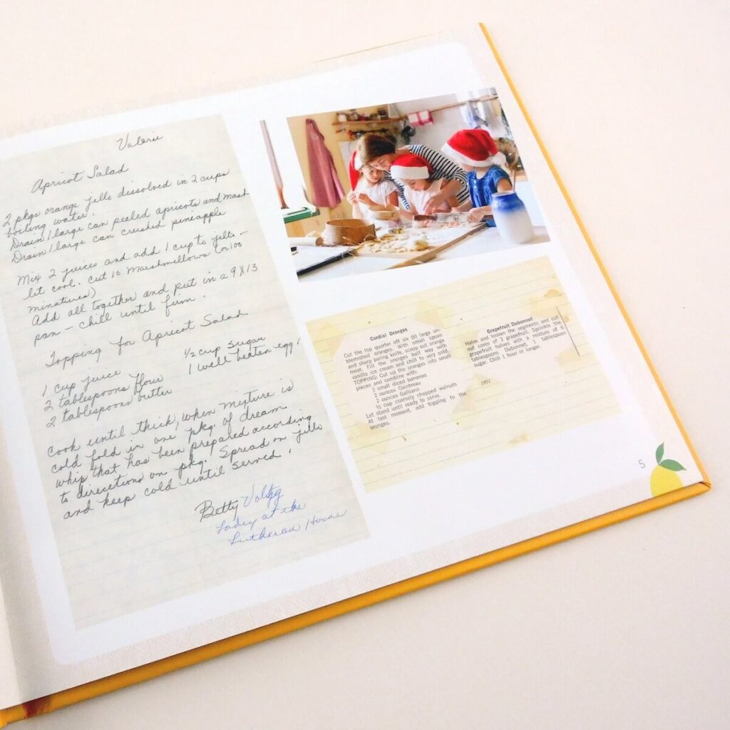 Photo of Plum Print family recipe book, showing a page with an image of a family cooking together and scanned, hand-written recipe.