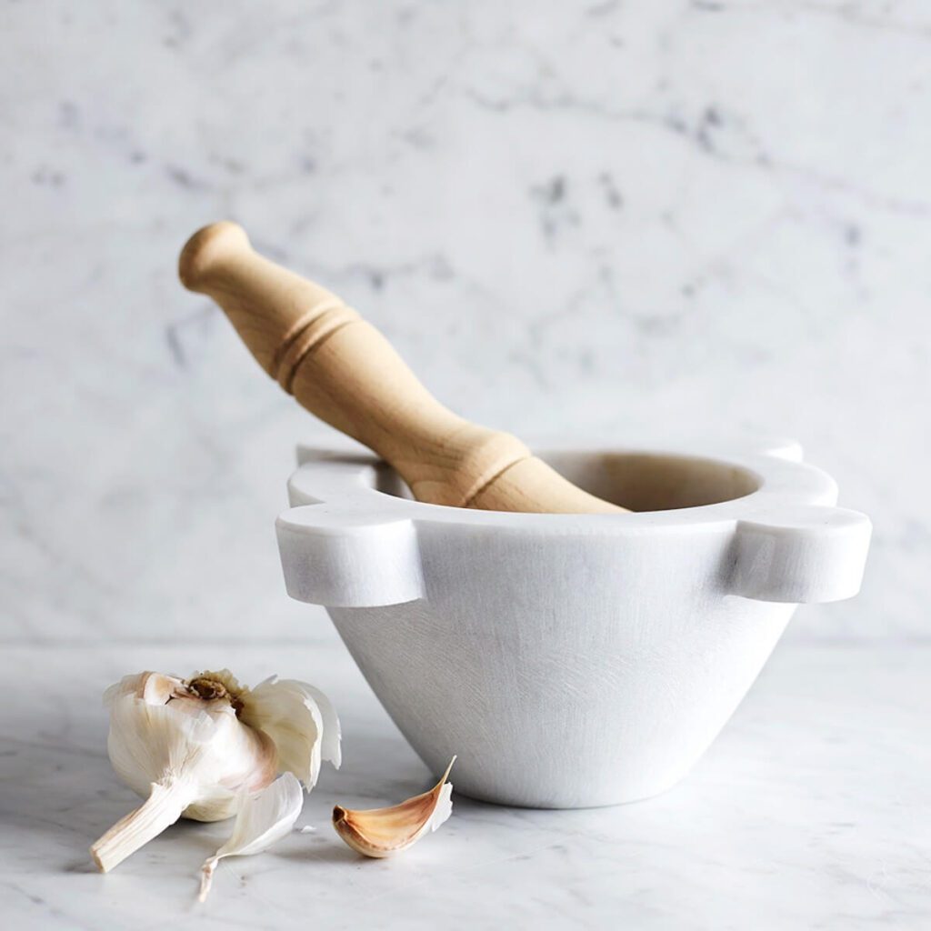 Image of Williams Sonoma's marble mortar and pestle sitting on a marble surface.